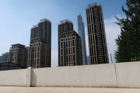 High-rises developed by Goldin Properties stand partially empty in Tianjin's high-tech zone, China, May 25, 2018. The Goldin Finance 117 landmark skysraper that is under construction is seen in the background. REUTERS/Yawen Chen