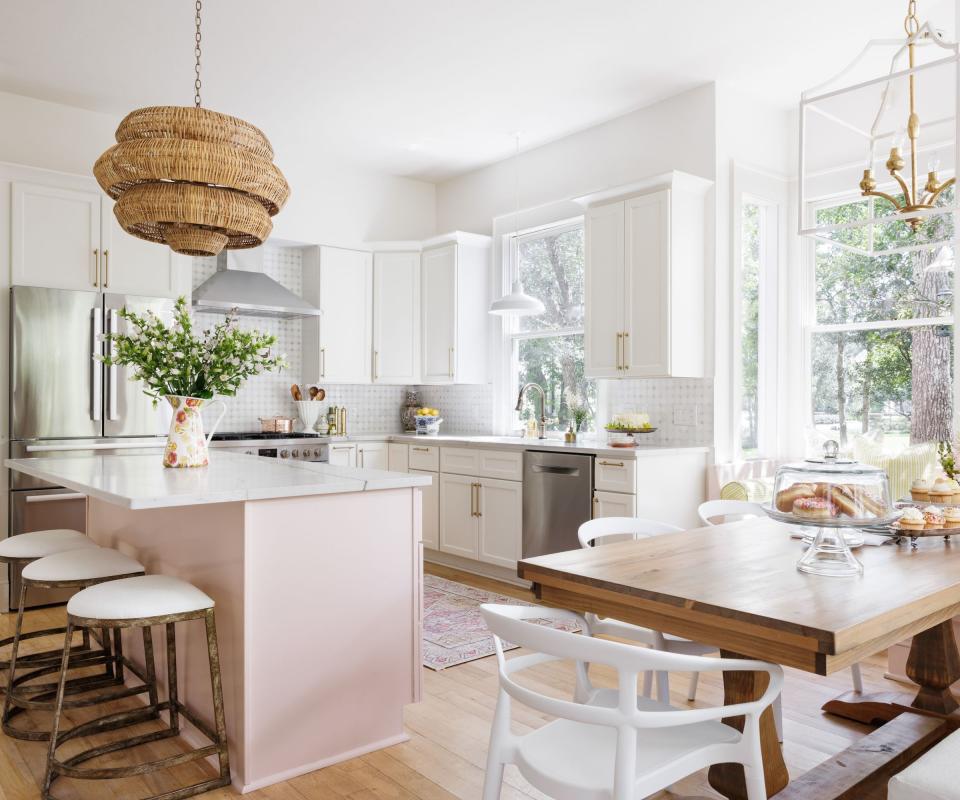 Kitchen with marble topped island with dining table in corner