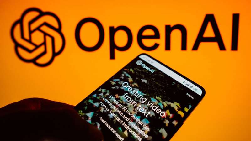 Open AI app on smartphone, in front of a larger company logo