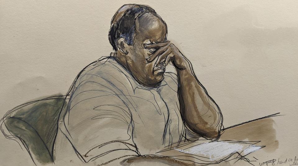 In this courtroom sketch, Frank James, listens as Judge Kuntz reads the updated charges against him in Brooklyn federal court, Tuesday, Jan. 3, 2023, in New York. James, who opened fire and wounded 10 passengers on a Brooklyn subway train last year has pleaded guilty to federal terrorism charges. Frank James admitted pulling the trigger on the Manhattan-bound train as it moved between stations on April 12. (Elizabeth Williams via AP)