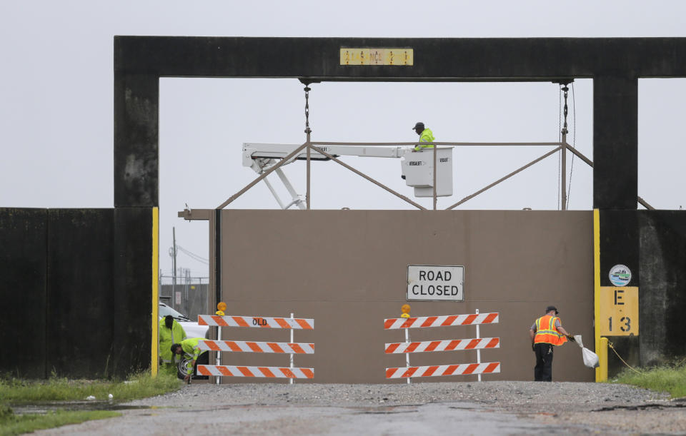 East crews open a gate on the east side of the Inner Harbor Navigational Canal, also known as the Industrial Canal, at Hayne Boulevard in New Orleans, Sunday, July 14, 2019. Tropical Depression Barry dumped rain as it slowly swept inland through Gulf Coast states Sunday, sparing New Orleans from a direct hit but stoking fears elsewhere of flooding, tornadoes, and prolonged power outages. (David Grunfeld/The Advocate via AP)