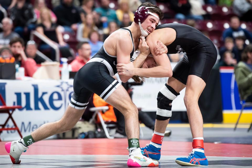 Faith Christian's Gauge Botero (left) wrestles Montgomery's Brandt Harer in the 121-pound championship bout at the PIAA Class 2A Wrestling Championships at the Giant Center on March 11, 2023, in Hershey. Botero won by decision, 5-1, to become FCA's first state champion in program history.