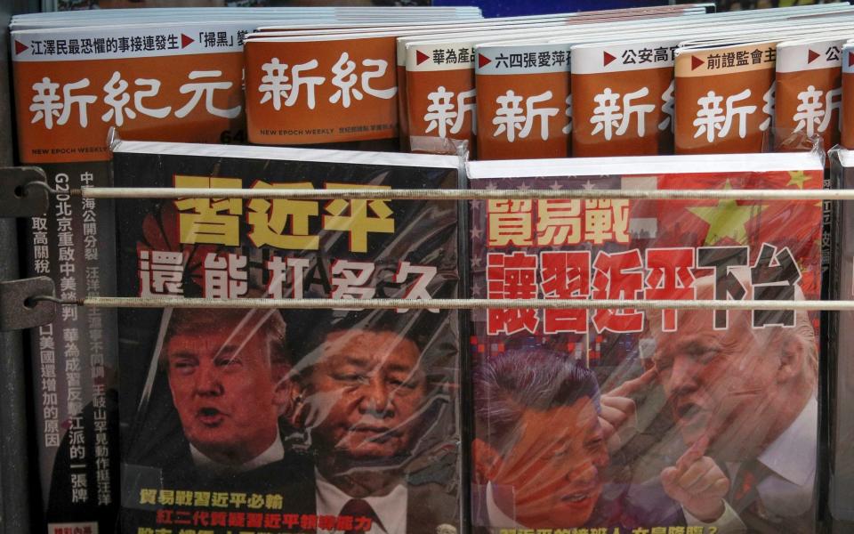 Chinese magazine covers with images of Donald Trump and Xi Jinping - AP