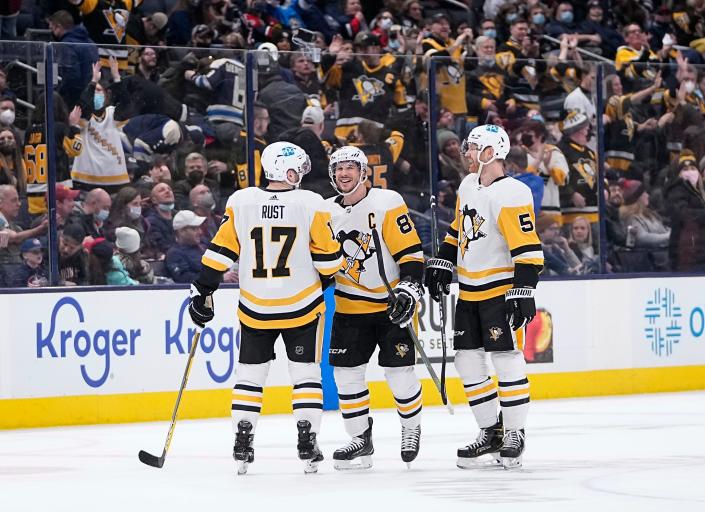 Pittsburgh Penguins right wing Bryan Rust (17) and defenseman Mike Matheson (5) celebrate a goal by center Sidney Crosby (87) during the third period of the NHL hockey game at Nationwide Arena in Columbus on Friday, Jan. 21, 2022. Pittsburgh won 5-2.