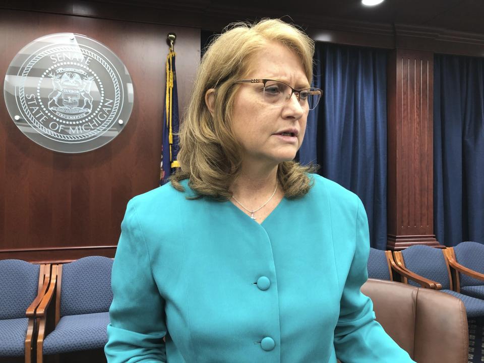 FILE - In this Tuesday, May 7, 2019, photo, Republican Michigan Sen. Lana Theis speaks with reporters in Lansing, Mich. Theis opened a Michigan Senate session with an invocation by claiming children are being attacked by "forces" that want to indoctrinate them with ideas their parents do not support. (AP Photo/David Eggert, File)