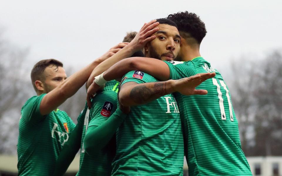 Watford captain Troy Deeney is embraced by his team-mates after he scores their second against Woking - Getty Images Europe