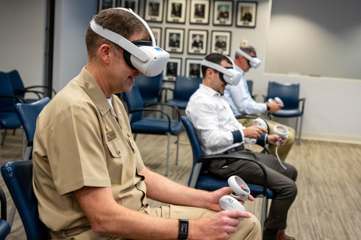 Capt. Andy Berner, ONR Global commanding officer, tries out a virtual bridge simulator at One Liberty Center in Arlington, Virginia on July 20, 2023. The bridge simulator is a commercially available application presented recently at a special London Tech Bridge Tea and Tech event.