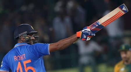 India's Rohit Sharma celebrates after completing his century during their first Twenty-20 cricket match against South Africa in the northern Indian hill town of Dharamsala, India, October 2, 2015. REUTERS/Adnan Abidi