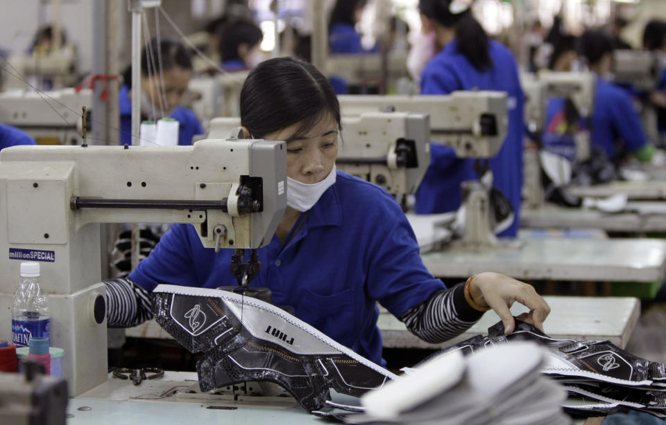 Workers sew up shoes at Thuong Dinh Shoe factory in Hanoi, Vietnam, Thursday, Nov. 20, 2008. Thuong Dinh Shoe factory produces shoes for domestic markets and for exports. The state-owned company established in 1957 also makes shoes for American Eagles, Baby Phat, Kappa, Fila among others. Shoe exports are among top of Vietnam's export earners, earning $4 billion last year.(AP Photo/Chitose Suzuki)