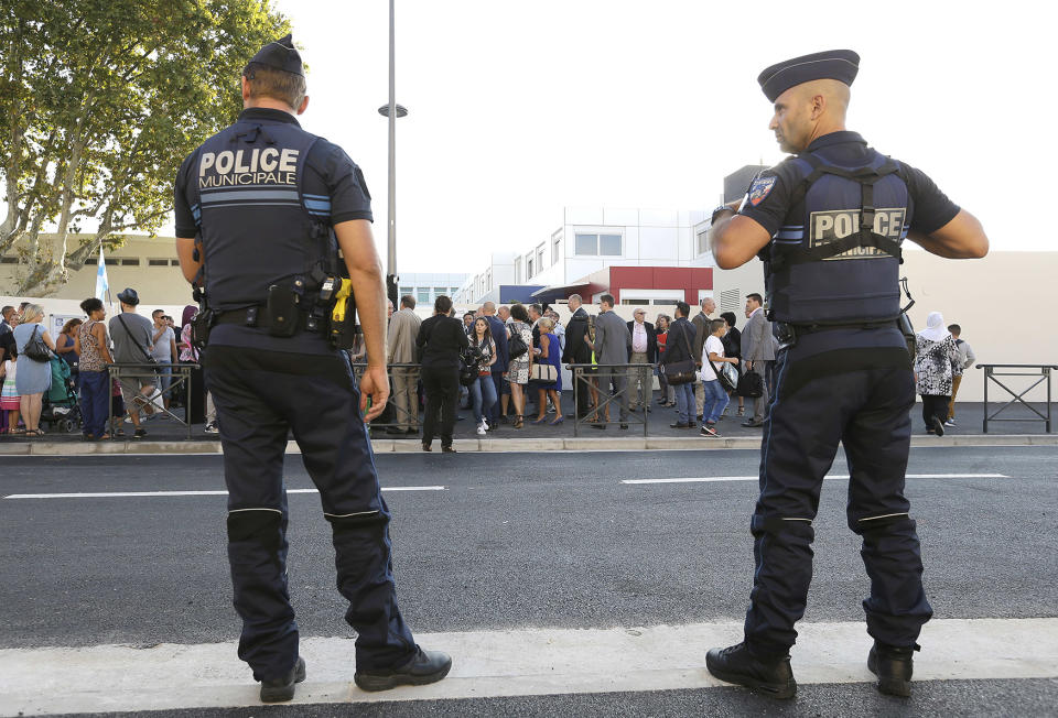 Policemen stand guard as part of general security procedures outside a school in Marseille