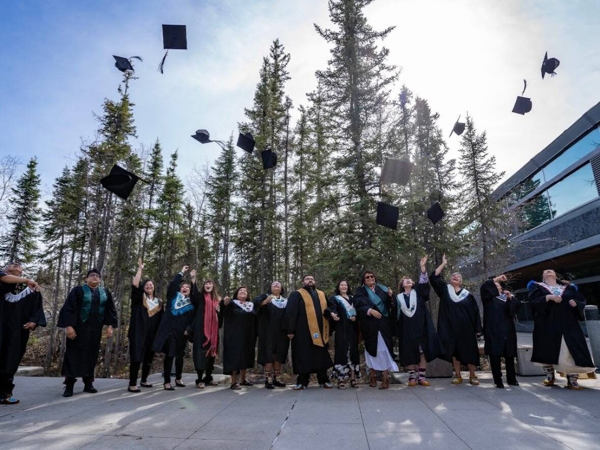 The first cohort of graduates celebrate their completion of the Northern Indigenous Counselling Program in May 2022. From left are Billy Archie, Johnny Ongahak, Tephaine Wedawin, Melissa Lennie, Lynsie Auger, Vanessa Sangris, Louisa Alunik, Lennie Fabian, Lina Koe-Peterson, Lorina Pierrot, Rita Green, Louise Nazon, Burnice Mandeville and Leanne Joss. (Submitted by Jean Erasmus - image credit)