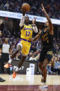 Los Angeles Lakers guard Dennis Schroder (17) shoots against Cleveland Cavaliers forward Evan Mobley (4) during the first half of an NBA basketball game Tuesday, Dec. 6, 2022, in Cleveland. (AP Photo/Ron Schwane)