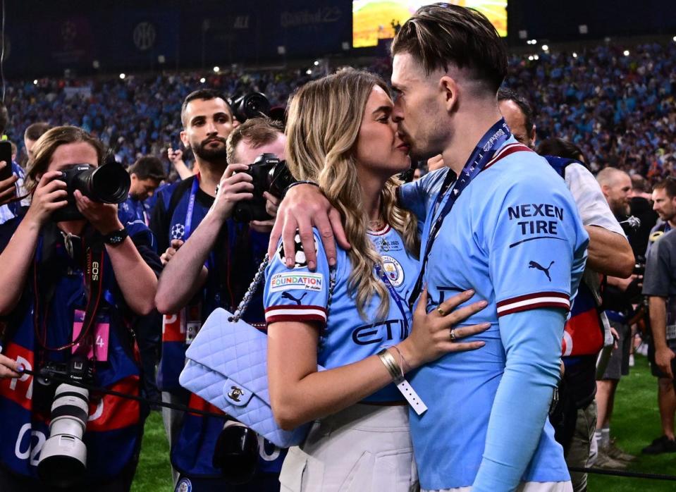 Grealish celebrates with his girlfriend Sasha Attwood after winning the UEFA Champions League final football match on June 10, 2023 (AFP via Getty Images)