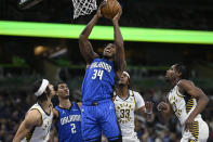 Orlando Magic center Wendell Carter Jr. (34) goes up for a shot as guard Caleb Houstan (2), Indiana Pacers guard Andrew Nembhard, left, center Myles Turner (33) and forward Aaron Nesmith (23) look on during the first half of an NBA basketball game, Sunday, March 10, 2024, in Orlando, Fla. (AP Photo/Phelan M. Ebenhack)