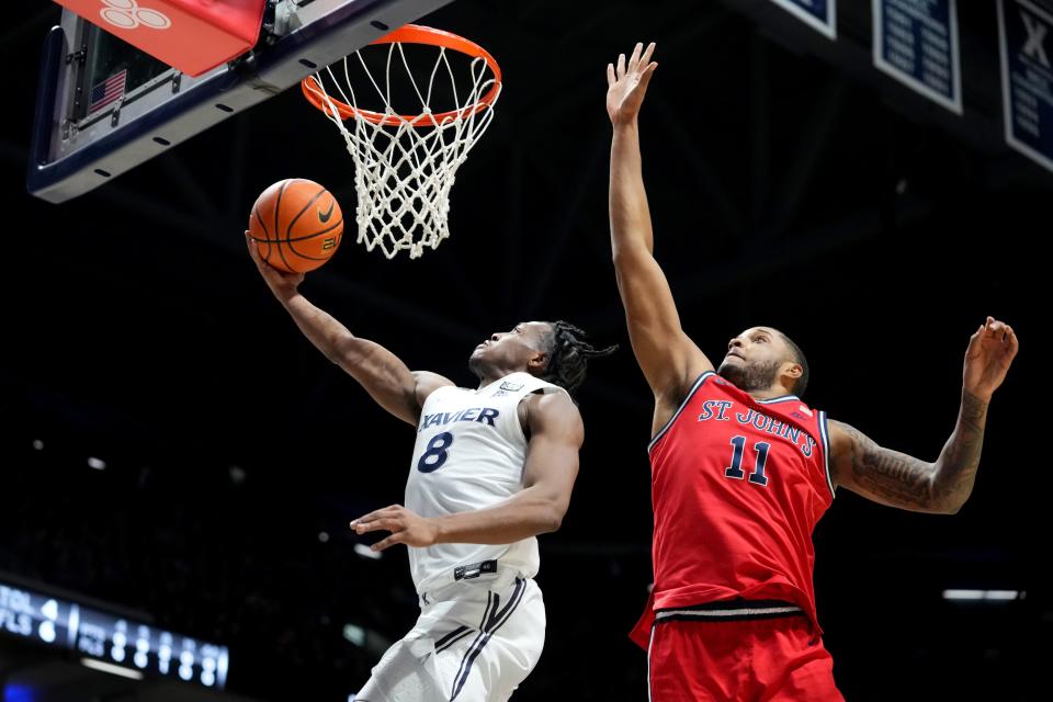 Xavier Musketeers guard Quincy Olivari (8) scores at the basket in the first half of a college basketball game between the St. John's Red Storm and the Xavier Musketeers, Wednesday, Jan. 31, 2024, at Cintas Center in Cincinnati.