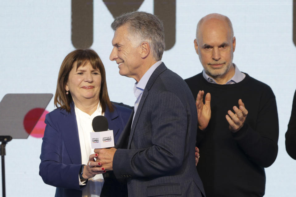 Presidential candidate Patricia Bullrich, left, former hopeful Horacio Rodríguez Larreta, right, with the United for Change coalition, and Argentina's former President Mauricio Macri, celebrate at their campaign headquarters after polling stations closed during primary elections in Buenos Aires, Argentina, Sunday, Aug. 13, 2023. (AP Photo/Daniel Jayo)