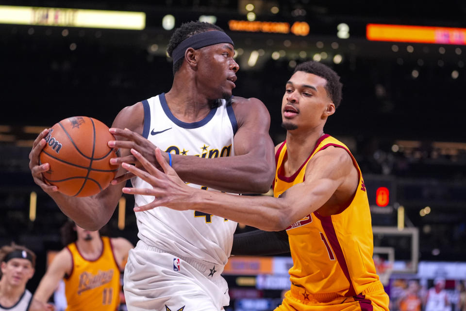 Victor Wimbanyama, right, of the San Antonio Spurs, defends against Oscar Tshiebwe, left, of the Indiana Mad Ants, during an NBA Rising Stars basketball game in Indianapolis, Friday, February 16, 2024. (AP Photo/Michael Conroy)