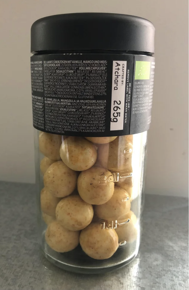 Jar of vanilla-flavored meringue cookies with ingredient list and price tag on label