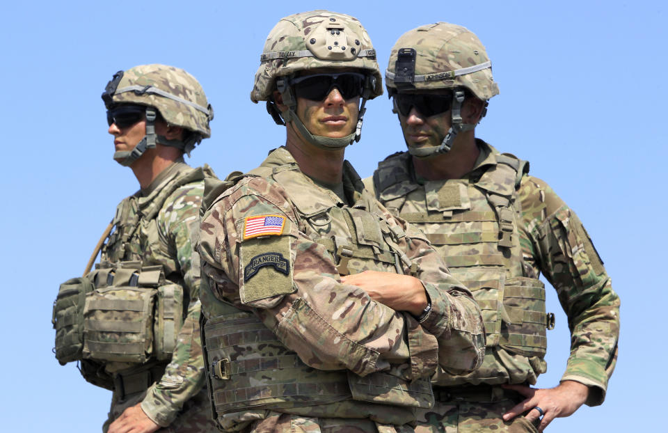 FILE - In this Wednesday, Aug. 9, 2017 file photo US soldiers take part in NATO-led Noble Partner 2017 multinational military exercises at the military base of Vaziani, outside Tbilisi, Georgia. After more than a year of thinly veiled threats that the United States could start pulling troops out of Germany unless the country increases its defense spending to NATO standards, President Donald Trump appears to be going ahead with the hardball approach with a plan to reduce the American military presence in the country by more than 25 percent. (AP Photo/Shakh Aivazov, file)