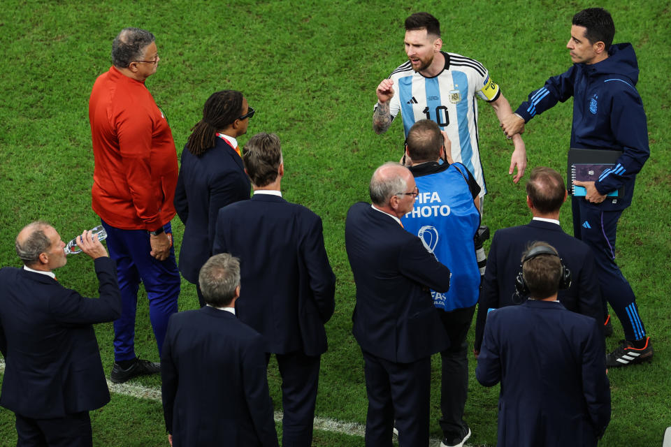 LUSAIL CITY, QATAR - DECEMBER 09: Lionel Messi #10 of Argentina talks with assistant coach Edgar Davids and head coach Louis van Gaal of Netherlands during the FIFA World Cup Qatar 2022 quarter final match between Netherlands and Argentina at Lusail Stadium on December 9, 2022 in Lusail City, Qatar. (Photo by Liu Lu/VCG via Getty Images)