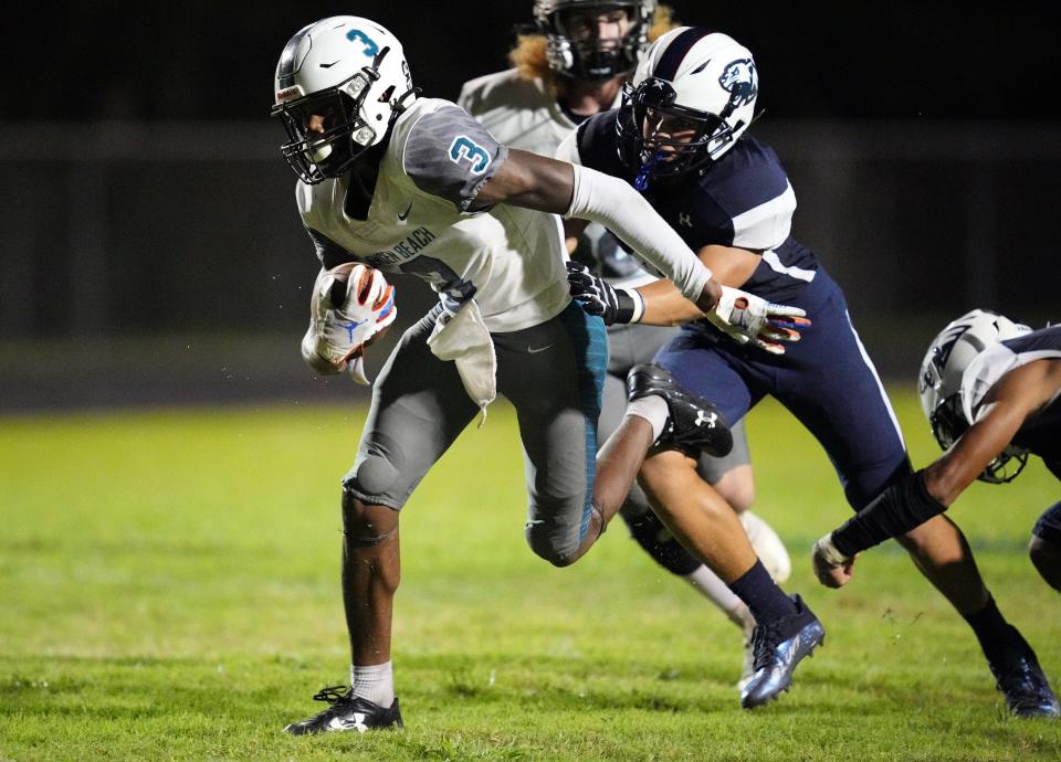 Jensen Beach’s Jamari Marshall (3) breaks free for a gain in the fourth quarter as Dwyer’s Chris Hurd (45) follows on the play on Friday, September 1, 2022 in Palm Beach Gardens.