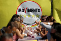 A 5-Star movement supporters have food during their gathering in Rimini, Italy, September 23, 2017. REUTERS/Max Rossi