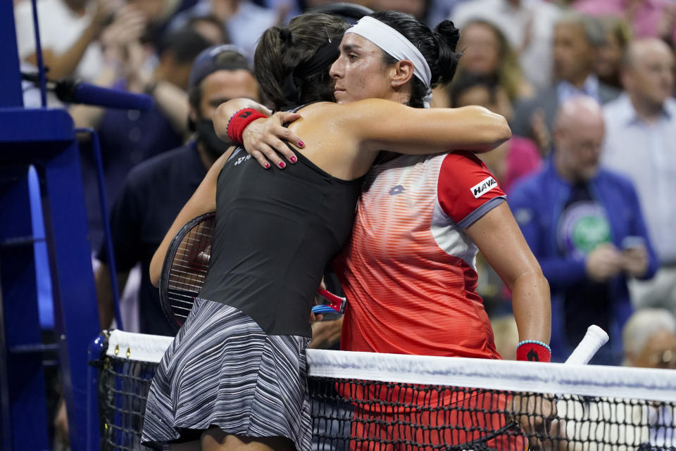 Ons Jabeur, of Tunisia, right, hugs Caroline Garcia, of France, after winning their semifinal match of the U.S. Open tennis championships, Thursday, Sept. 8, 2022, in New York. (AP Photo/John Minchillo)