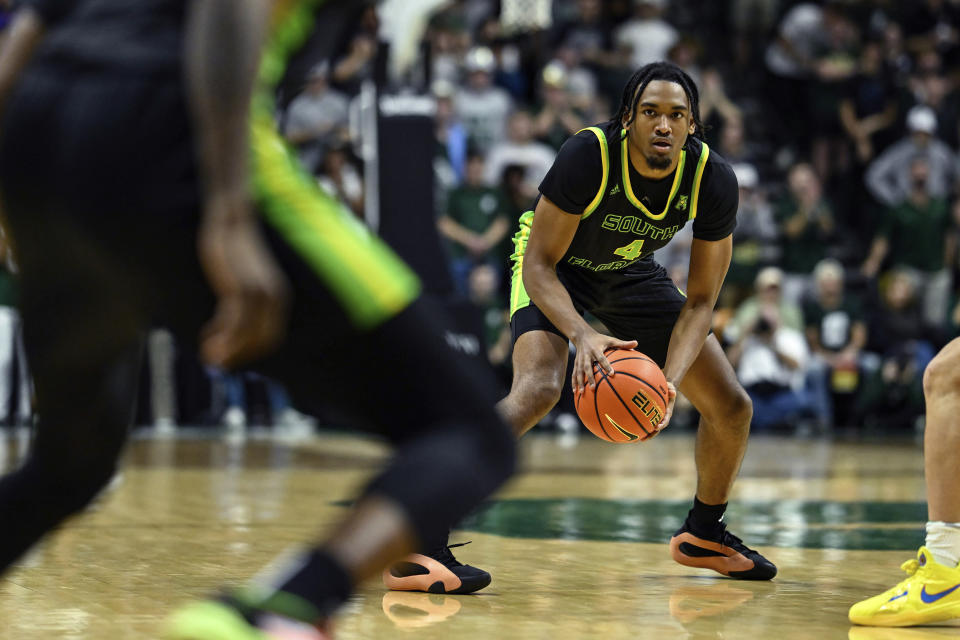 South Florida guard Kobe Knox (4) looks to pass the ball during the first half of an NCAA college basketball game against Charlotte on Saturday, March 2, 2024, in Charlotte, N.C. (AP Photo/Matt Kelley)