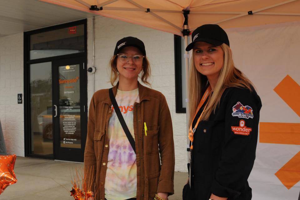 Tammy Lough, project manager, left, and Kierston Powell, senior marketing manager, greet customers on the first day of opening at Sunnyside Cannabis Dispensary in Somerset Borough.