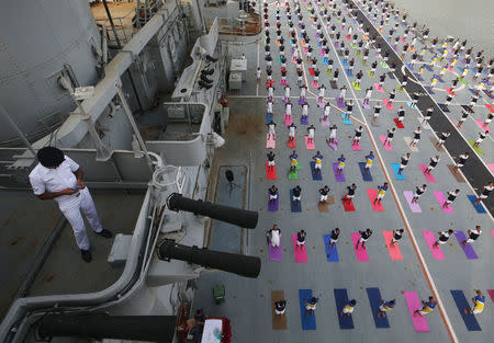Members of the Indian Navy perform yoga on the flight deck of INS Viraat, an Indian Navy's decommissioned aircraft carrier, during International Yoga Day in Mumbai, India, June 21, 2018. REUTERS/Francis Mascarenhas