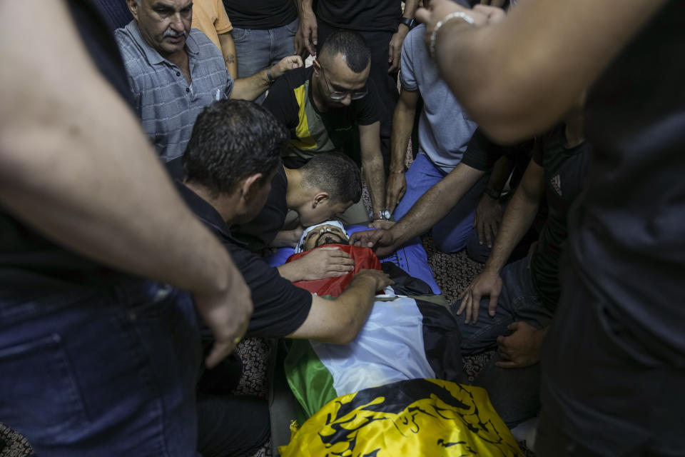 Palestinians mourn Hussein Yousef Rabee, 25, during his funeral in the West Bank Dheisheh refugee camp, near Bethlehem, Monday, Oct. 30, 2023. Rabee was killed on Sunday during an Israeli army raid in the refugee camp, the Palestinian Ministry of Health said. (AP Photo/Mahmoud Illean)