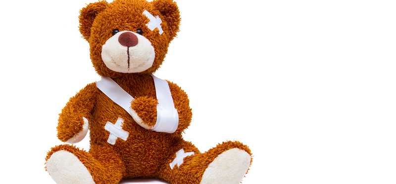 A teddy bear with bandages and a sling.