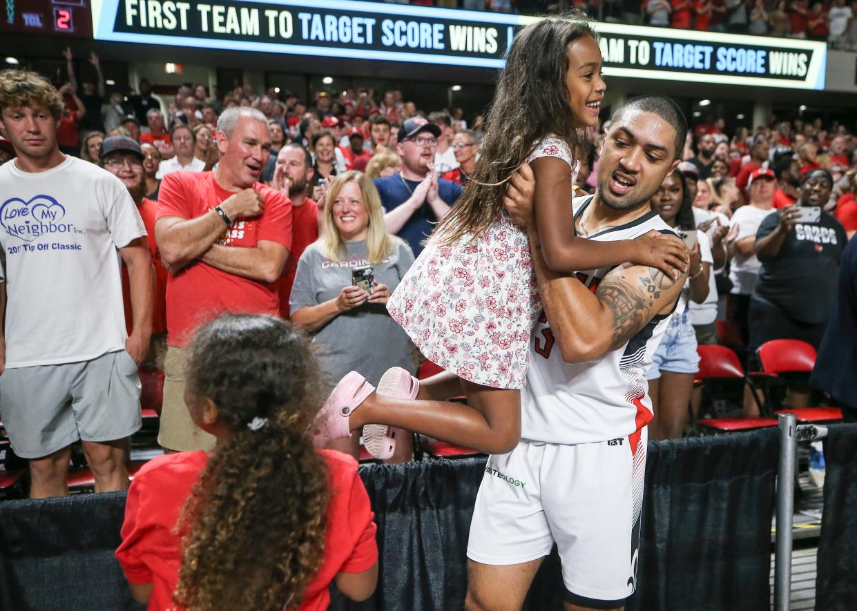 Former Louisville star Peyton Siva lifts his daughters onto the court after his team TheVille  defeated Jackson TN at the TBT second round of the Louisville Regional at Freedom Hall July 27, 2023.