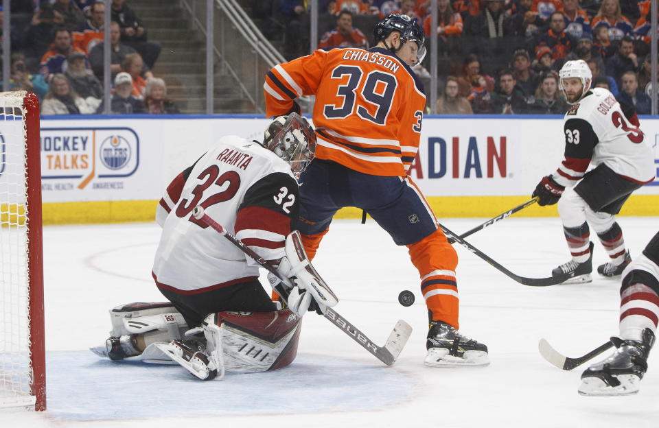 Arizona Coyotes goalie Antti Raanta (32) makes the save as Edmonton Oilers' Alex Chiasson (39) screens during second period NHL action in Edmonton, Alberta, on Saturday, Jan. 18, 2020. (Jason Franson/The Canadian Press via AP)