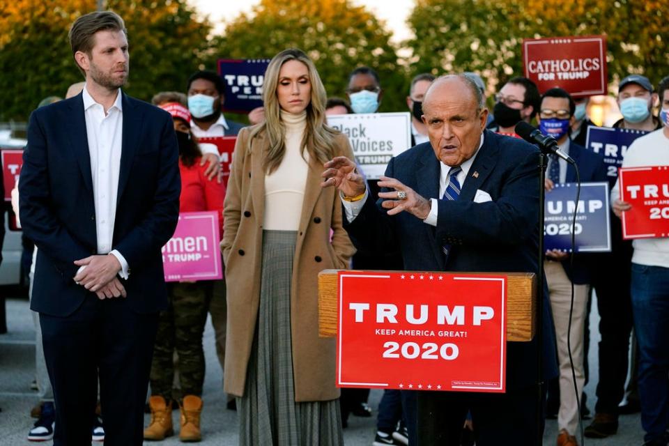 Rudy Giuliani, a lawyer for President Donald Trump, speaks during a news conference on legal challenges to vote counting in Pennsylvania on Nov. 4 in Philadelphia. At left are Eric Trump, the president's son, and his wife, Lara.