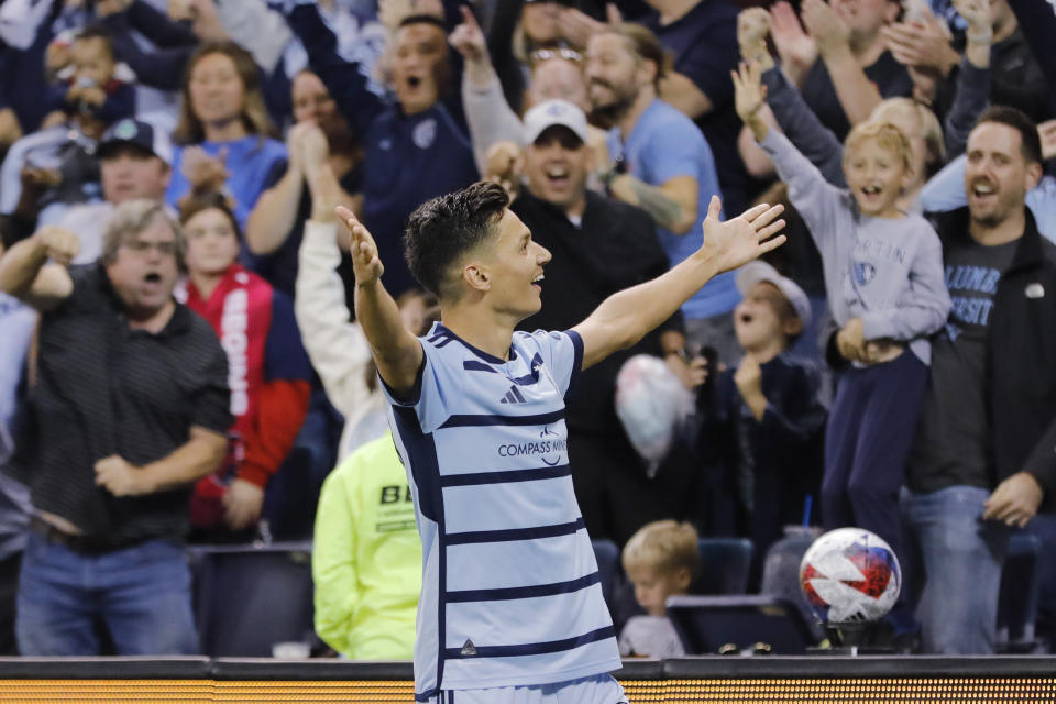 Sporting Kansas City forward Dániel Sallói celebrates with fans after scoring against St. Louis City during the second half of an MLS playoff soccer match, Sunday, Nov. 5, 2023, in Kansas City, Kan. (AP Photo/Colin E. Braley)