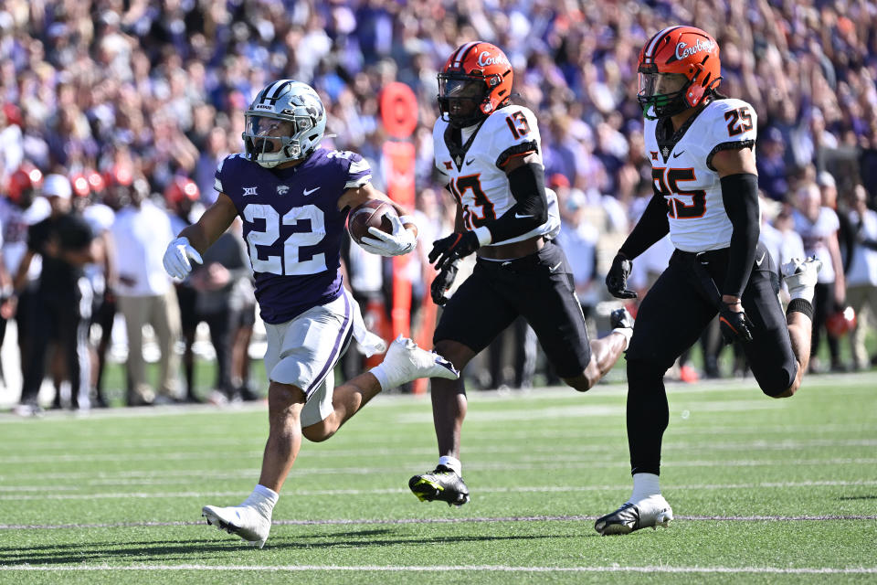 MANHATTAN, KS - OCTOBER 29:  Running back Deuce Vaughn #22 of the Kansas State Wildcats rushes for a touchdown past safety Thomas Harper #13 of the Oklahoma State Cowboys during the first half at Bill Snyder Family Football Stadium on October 29, 2022 in Manhattan, Kansas. (Photo by Peter Aiken/Getty Images)