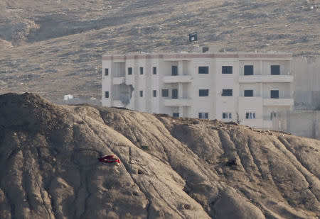 A black flag belonging to the Islamic State is seen near the Syrian town of Kobani, as pictured from the Turkish-Syrian border near the southeastern town of Suruc in Sanliurfa province, October 6, 2014. REUTERS/Umit Bektas