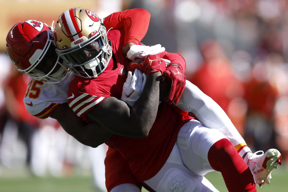 San Francisco 49ers wide receiver Deebo Samuel, foreground, is tackled by Kansas City Chiefs cornerback Jaylen Watson during the first half of an NFL football game in Santa Clara, Calif., Sunday, Oct. 23, 2022. (AP Photo/Jed Jacobsohn)