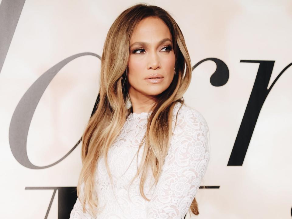 Jennifer Lopez in a short, white, lace bridal gown at the premiere of "Marry Me"