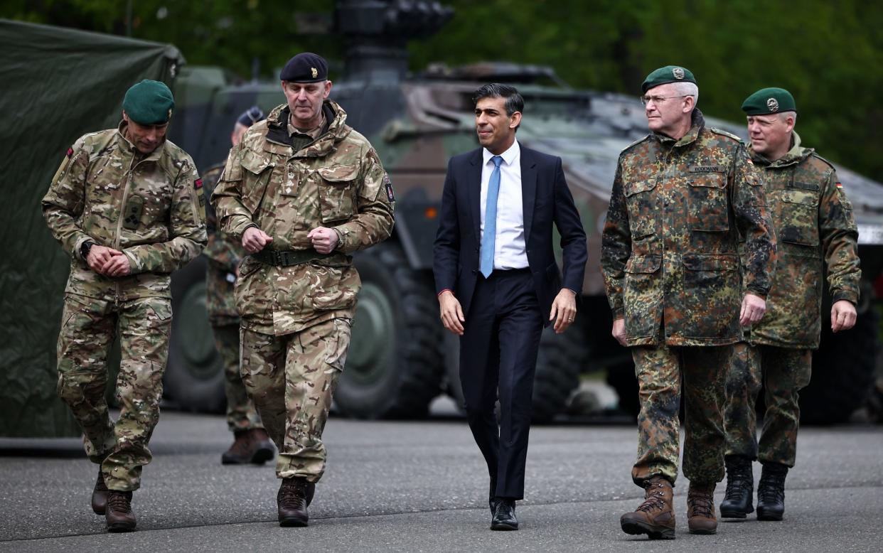 Prime Minister Rishi Sunak walks with German Lieutenant General Andre Bodemann (2nd right) and military personnel of British troops as he visits the Julius Leber Barracks in Berlin