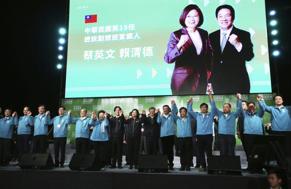 Taiwan's 2020 presidential election candidate, Taiwanese President Tsai Ing-wen, center, celebrate victory with supporters in Taipei, Taiwan, Saturday, Jan. 11, 2020. Taiwan's independence-leaning President Tsai Ing-wen won a second term in a landslide election victory Saturday, signaling strong support for her tough stance against China. (AP Photo/Chiang Ying-ying)