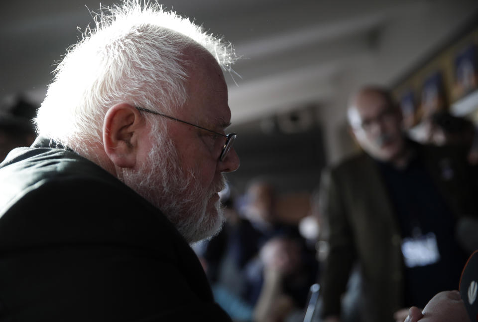 Cardinal Reinhard Marx, left, listens to sex abuse survivor Jean-Marie Fuerbringer, from Switzerland, as he meets member of the ECA (Ending Clergy Abuse), in Rome, Friday, Feb. 22, 2019. (AP Photo/Alessandra Tarantino)