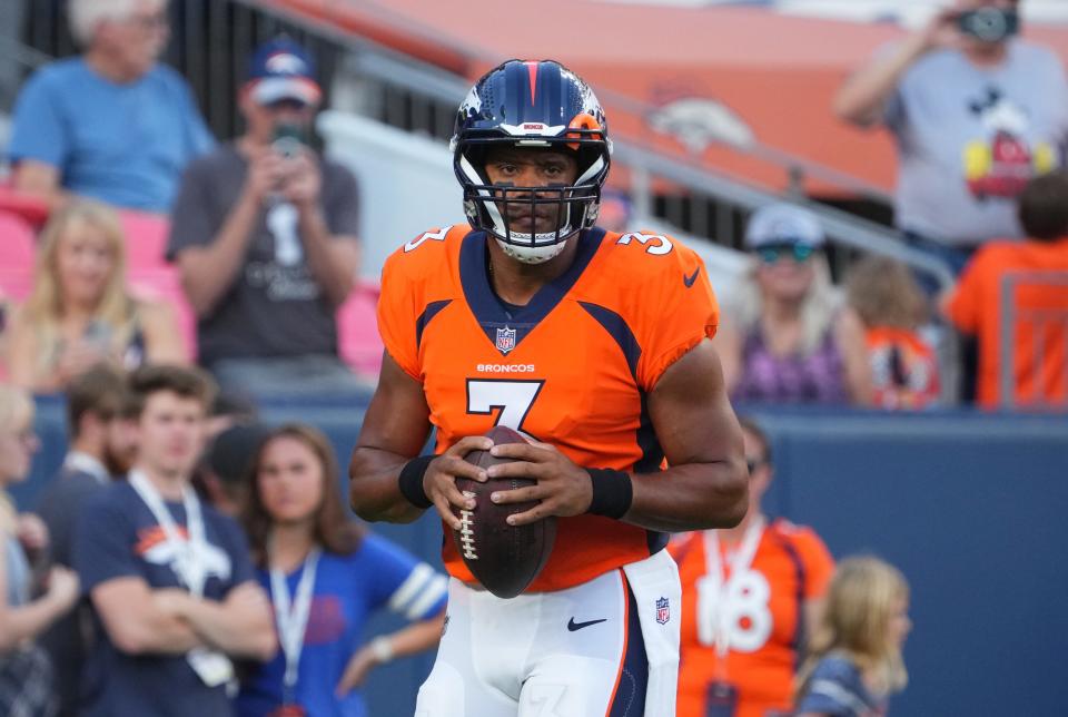 Denver Broncos quarterback Russell Wilson warms up before a preseason game against the Minnesota Vikings at Empower Field at Mile High.