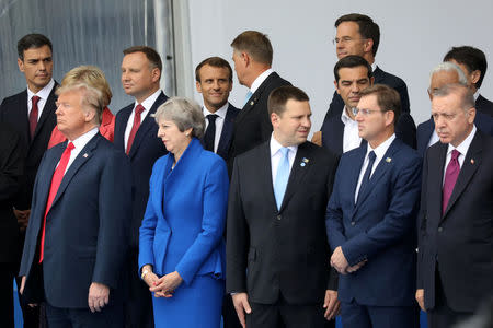 U.S. President Donald Trump, Britain's Prime Minister Theresa May, Estonia's Prime Minister Juri Ratas, Slovenia's Prime Minister Miro Cerar, Turkey's President Tayyip Erdogan, Spain's Prime Minister Pedro Sanchez, Poland's President Andrzej Duda, French President Emmanuel Macron, Romania's President Klaus Werner Iohannis, Netherlands' Prime Minister Mark Rutte and Greek Prime Minister Alexis Tsipras pose for a family picture ahead of the opening ceremony of the NATO (North Atlantic Treaty Organization) summit, at the NATO headquarters in Brussels, Belgium, July 11, 2018. Ludovic Marin/Pool via REUTERS