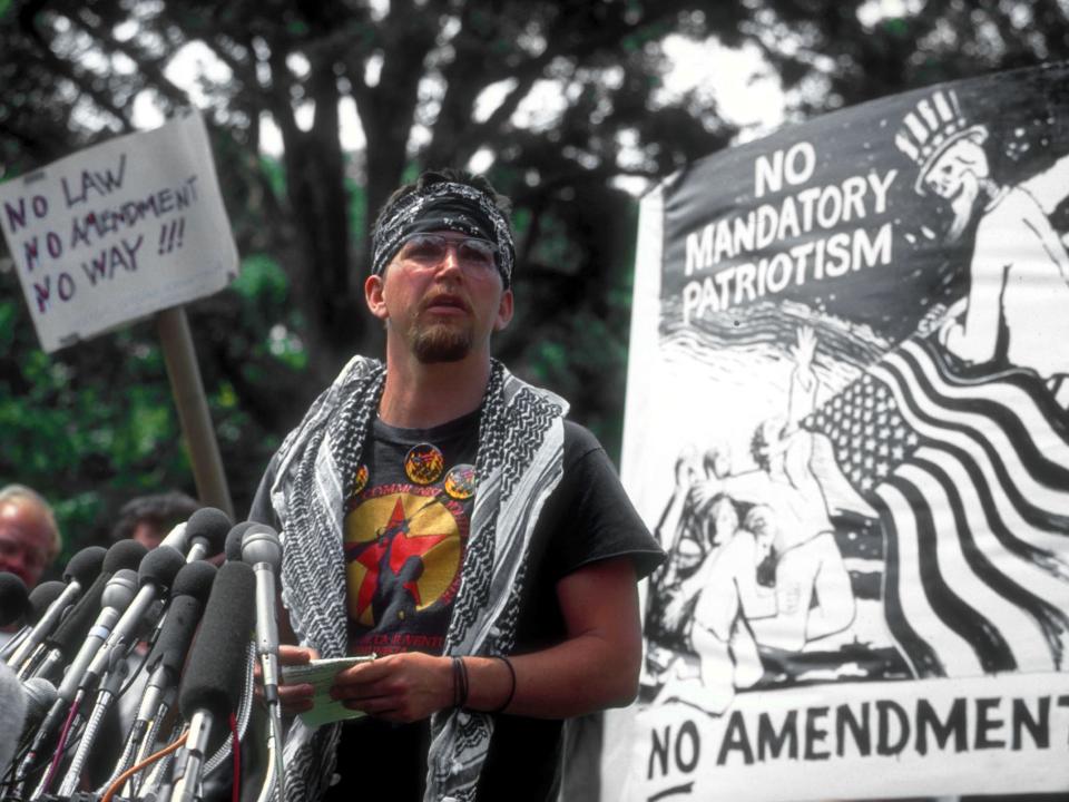 Gregory Johnson, defendant in flag burning case, speaking against constitutional amendment banning flag desecration, outside Capitol.