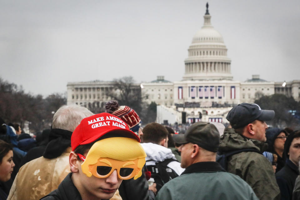 <p>Spectators wait in the rain on the National Mall in Washington, Friday, Jan. 20, 2017, before the presidential inauguration of Donald Trump. (Photo: John Minchillo/AP) </p>