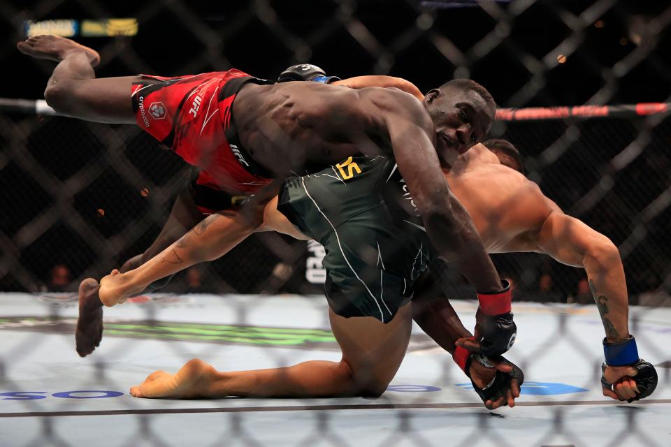 David Onama takes down Gabriel Santos in a featherweight bout during UFC Fight Night in Jacksonville.
