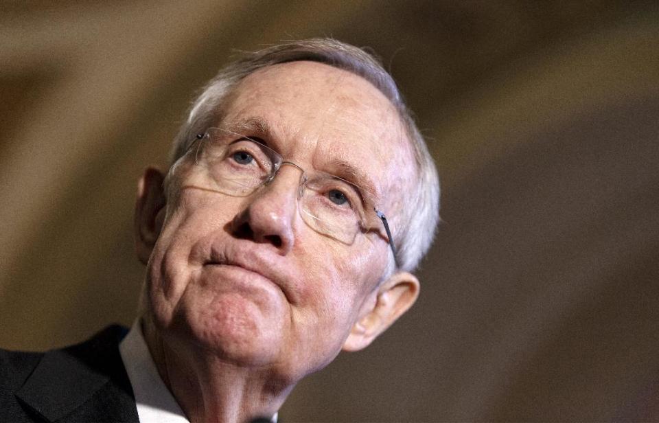 FILE - This April 8, 2014 file photo shows Senate Majority Leader Harry Reid of Nev. pausing during a news conference on Capitol Hill in Washington. Flip sides of the same campaign-season coin, the Republican drive in Congress to repeal the nation’s health care law and the Democratic call to close the pay gap for women have much in common. Divided government assures that neither has even a remote chance of becoming law anytime soon. Instead, they figure prominently in rival strategies to maximize turnout in the fall _ Democrats hoping women will vote in huge numbers, while Republicans try to stoke election year enthusiasm among tea party activists and other conservatives. (AP Photo/J. Scott Applewhite, File)