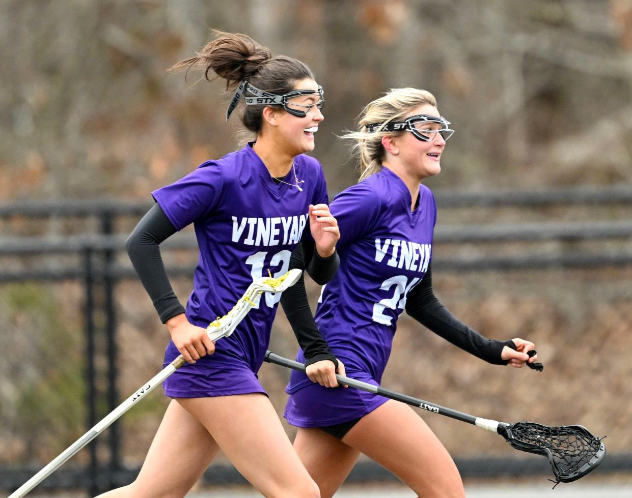 Ali Dyke (13) and Beatrice Welch race toward their Martha's Vineyard goalie after defeating Monomoy 10-9 in lacrosse.